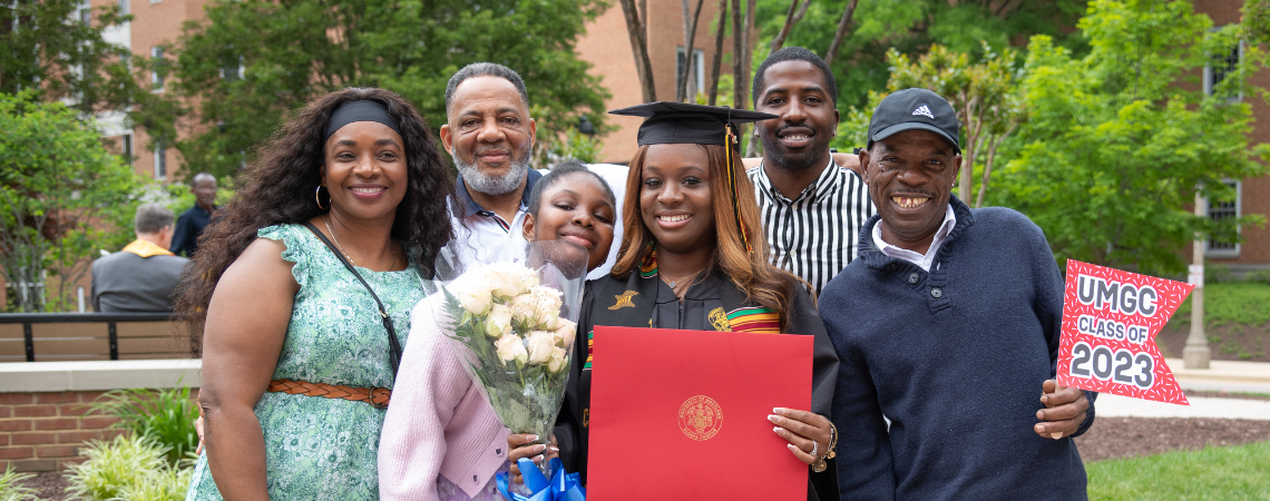 Recent UMGC Graduate with their family